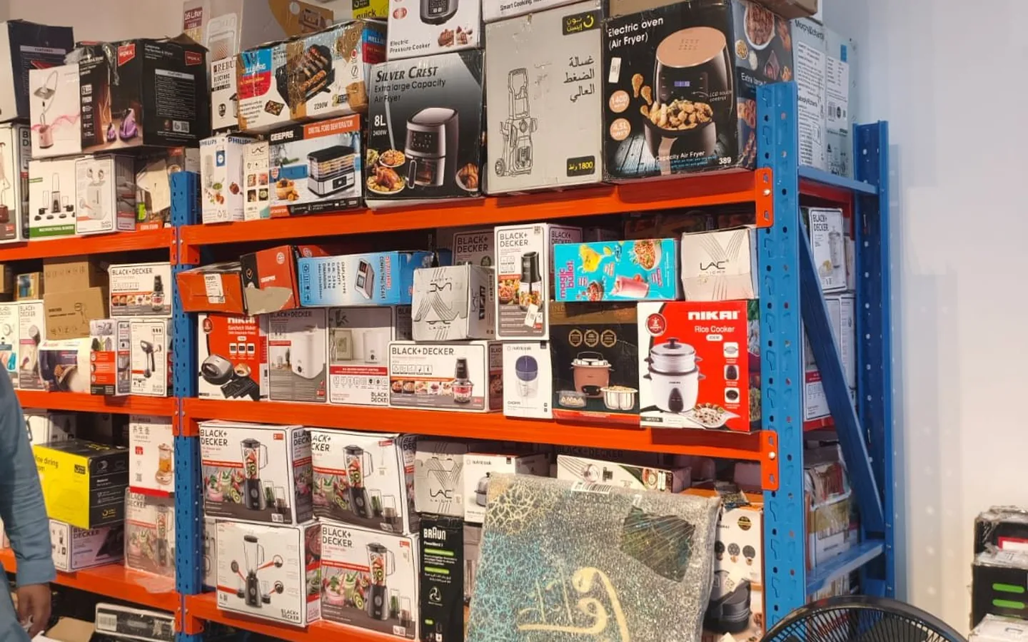 Mixed kitchen and household appliances displayed inside Prime Open Box
